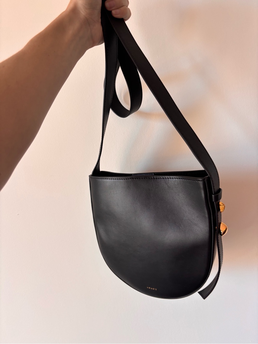 Black Half-Moon Leather Crossbody Bag with Gold Accents